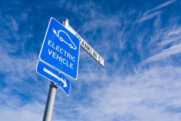Electric vehicle sign with blue sky stock photo