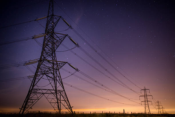 Electrical Pylons at Night A striking and crisp scene of Electrical Pylons taken at night in a small town called Littleborough in the UK. electricity pylon stock pictures, royalty-free photos & images