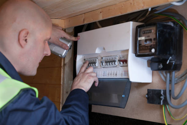 Electrician checking a domestic consumer unit fuse board stock photo