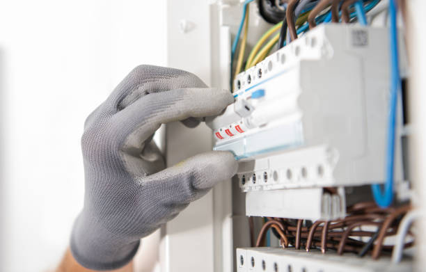 Electrician Testing Fuses In the Electric Box stock photo