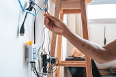 istock Electrician working home client 1337259234