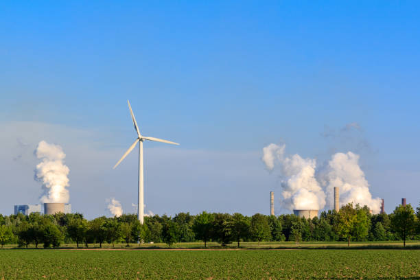 Electricity by wind power versus coal power stock photo