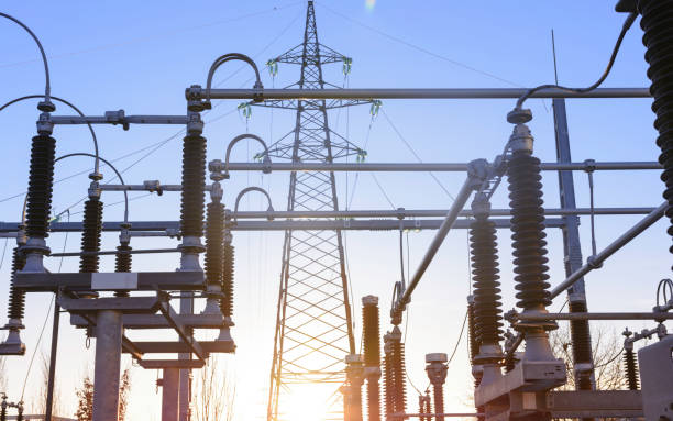 Electricity pylon and power lines in distribution electricity substation Power station on a sunset, close up of a high voltage transformer in power substation. high voltage sign photos stock pictures, royalty-free photos & images