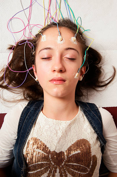 Electroencephalography Actual Electroencephalography (EEG) recording net being used on a young girl. EEG is the recording of the brain's spontaneous electrical activity over a short period of time. electrode stock pictures, royalty-free photos & images