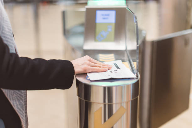 Electronic Boarding pass and passport control in the airport - hand with boarding pass at the turnstile. Electronic Boarding pass and passport control in the airport - hand with boarding pass at the turnstile. emigration and immigration photos stock pictures, royalty-free photos & images