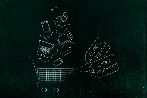 electronic devices falling into shopping cart with price tags with Black Friday and Cyber Monday text stock photo