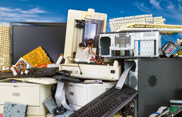 Electronic, plastic and metal waste on a dump of discarded computer components. Refuce sorting and disposal stock photo