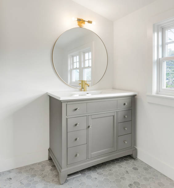 Elegant Bathroom Vanity in New Luxury Home with Circular Mirro bathroom in new home vanity stock pictures, royalty-free photos & images