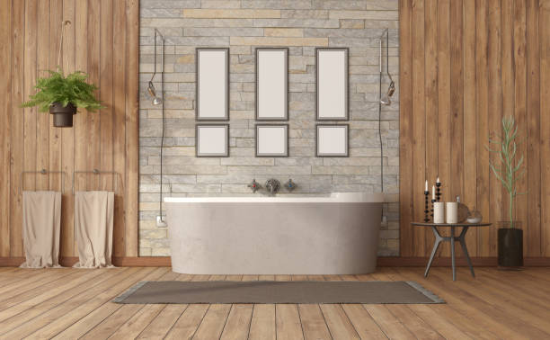 Elegant bathroom with bathtub against stone wall stock photo