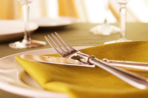Close-up shot of elegant dinner table setting with shallow depth of field.