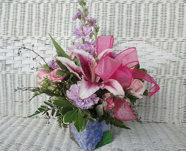 Elegant Flower Arrangement on a White Wicker Seat stock photo