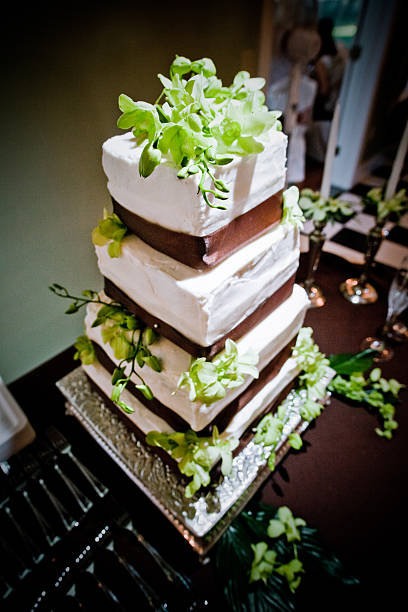 Elegant Four Tier Square Wedding Cake With Brown And Green Stock