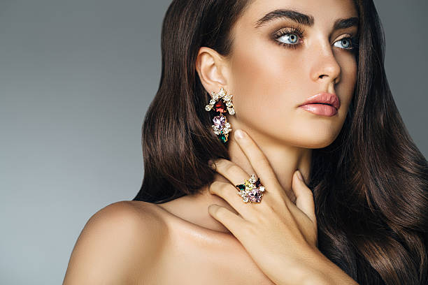 Elegant girl advertising jewelry Elegant girl advertising jewelry. Professional make-up. precious gem stock pictures, royalty-free photos & images