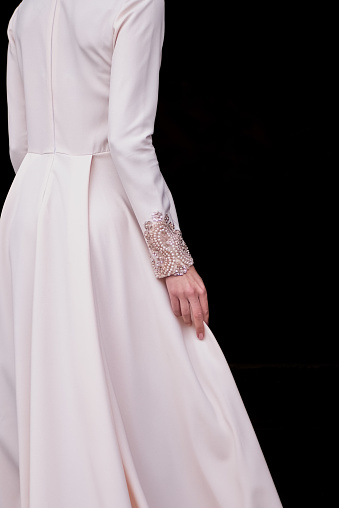 Elegant wedding dress with long skirt and beaded sleeves