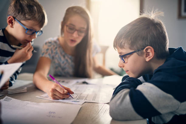Elementary school kids doing homework at home Teenage girl is helping her younger brother with homework. The girl is explaining the questions on the paper.
Nikon D850 boys glasses stock pictures, royalty-free photos & images