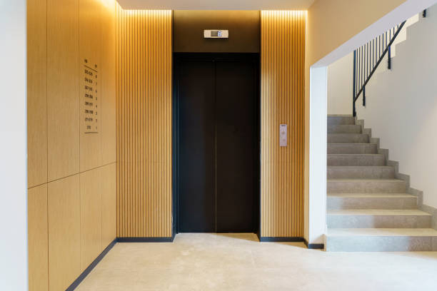 Elevator in the lobby hall of an apartment building. Modern decor and wood finishing of the ground floor and entrance. stock photo
