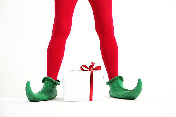 Elf legs Elf legs with christmas present elf stock pictures, royalty-free photos & images