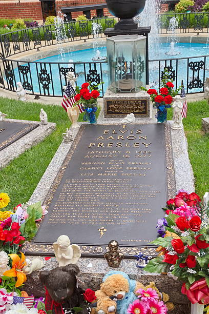 Elvis Presley Grave at Graceland, Memphis, TN "Memphis, TN, United States - June 18, 2011: The grave of Elvis Presley at Graceland, Memphis, TN, and it's gifts left by tourists who come by daily." graceland stock pictures, royalty-free photos & images