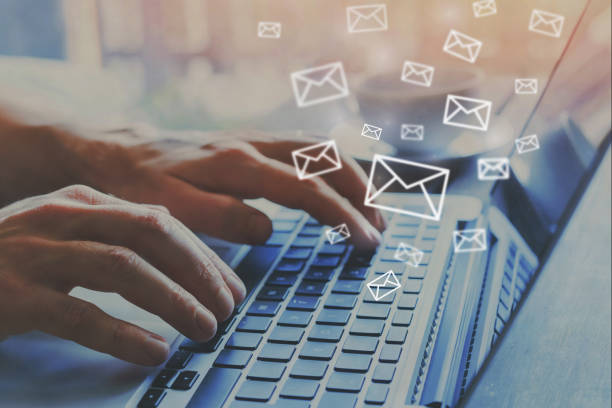 email marketing concept, e-mail icons email marketing concept, e-mail icons, hands typing on keyboard as background sending stock pictures, royalty-free photos & images