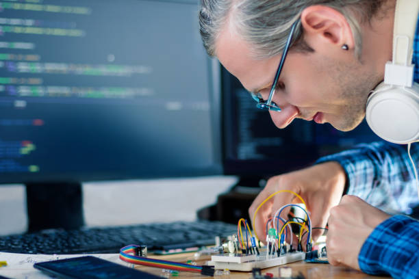 Embedded developer working with microcontrollers stock photo
