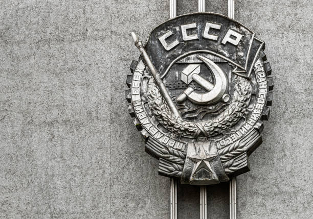 Emblem of the Soviet Union, sickle and hammer Soviet Union nation symbol. Emblem of the Soviet Union, sickle and hammer Soviet Union nation symbol on the stone wall. pskov russia stock pictures, royalty-free photos & images