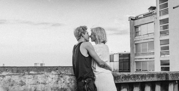 Embracing couple on the rooftop stock photo