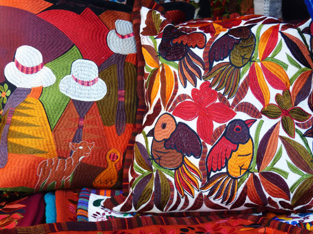 Embroidered decorative pillows, Ecuador Close up of сolorful embroidered decorative textile pillows at the artisan's market in Otavalo, Ecuador. Otavalo city is famous for the skills of it's citizens in trade and monufacturing textiles and is one of the most famous markets and visited spots by tourists in South America and in Ecuador decorative art stock pictures, royalty-free photos & images