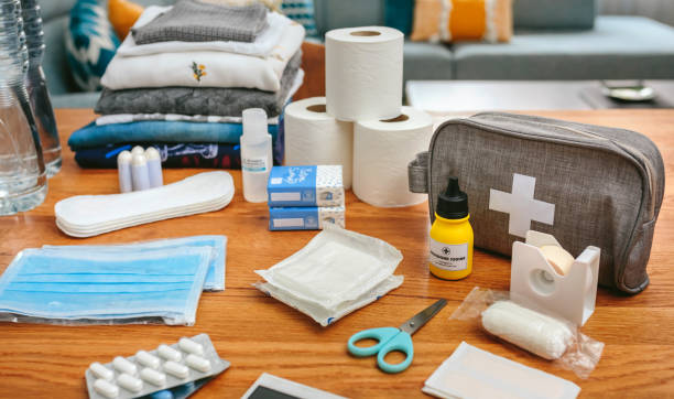 Emergency backpack equipment with first aid kit organized on the table stock photo
