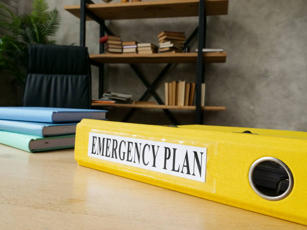 Emergency plan in the yellow folder on the desk. stock photo