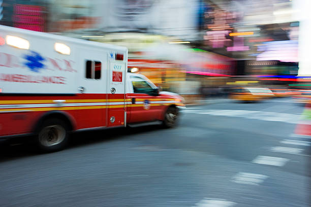 Emergency Time Square Ambulance zooming through Times Square NYC. 911 new york stock pictures, royalty-free photos & images