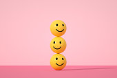 istock Emoji with smiley face on pink background 1366824713