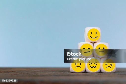 istock Emoticon icons face on Wooden Cube , Costumer service concept 1163339325