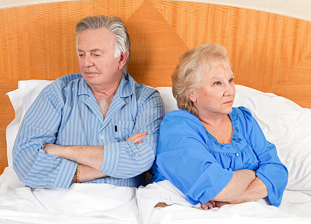 Old Couple Visiting Young Male Doctor Stock Image - Image 