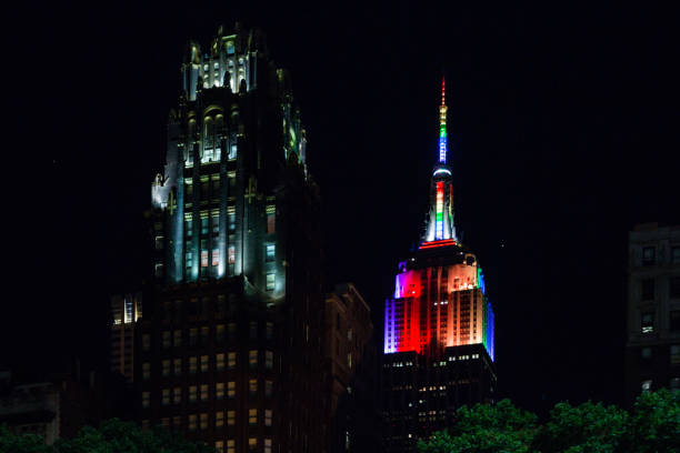 Empire State Building in rainbow flag during annual Pride Parade Night Empire State Building dressed in the rainbow flag during Pride Parade Night NYC. View from Bryant Park. New York LGBT community celebration day. It's Pride Month, which means LGBTQ revelers from around the globe come together for the NYC's massive Gay Pride Parade. nyc pride parade stock pictures, royalty-free photos & images