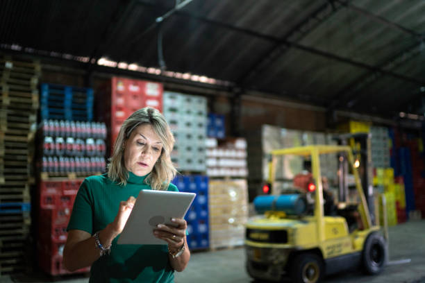 Employee using digital tablet at warehouse Employee using digital tablet at warehouse market retail space stock pictures, royalty-free photos & images