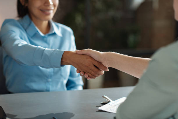 Employer greeting candidate at meeting stock photo