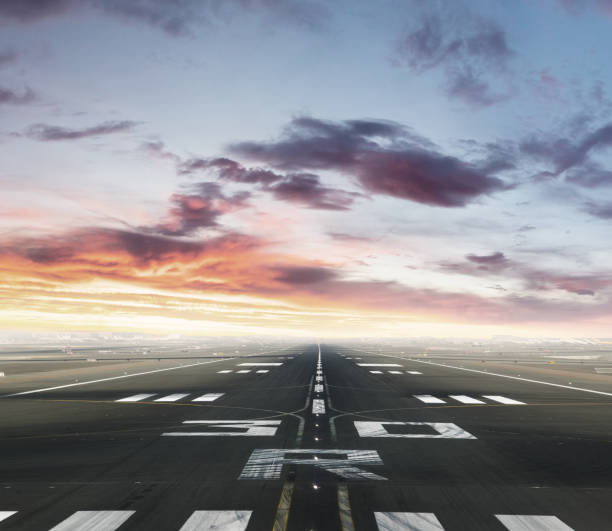 Empty airport runway in sunset Empty airport runway. Concept of modern and fastest mode of transportation. Dramatic sunset sky on background airport runway stock pictures, royalty-free photos & images