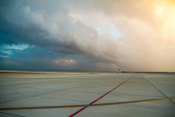 Empty airport with awesome sky impressive sky scene at the airport runway. airfield photos stock pictures, royalty-free photos & images