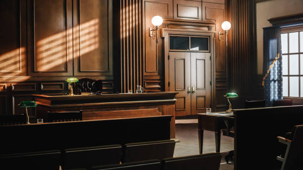 Empty American Style Courtroom. Supreme Court of Law and Justice Trial Stand. Courthouse Before Civil Case Hearing Starts. Grand Wooden Interior with Judge's Bench, Defendant's and Plaintiff's Tables. stock photo