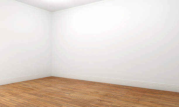 Empty apartment room with white walls and brown parquet stock photo