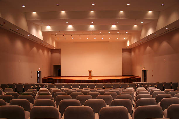 Empty auditorium with grey seats and downlights stock photo