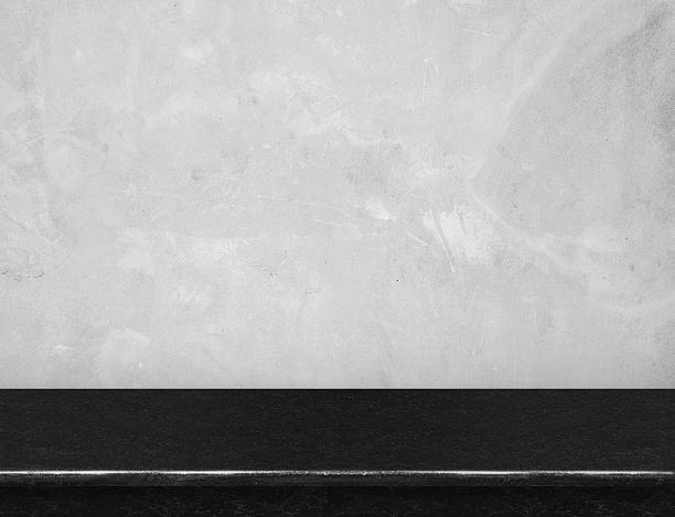 Empty black marble table top with grey concrete wall stock photo