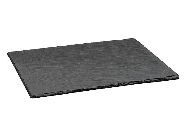 Empty black slate plate isolated on white background stock photo