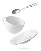 istock Empty dishes cup, plate and spoon are flying on a white. Isolated 1324562726