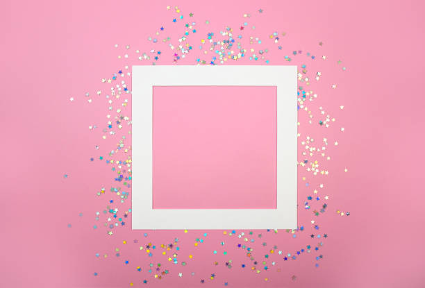 Empty frame square paper card and stars confetti flat lay on pink pastel background with copy space. Festive concept Empty frame square paper card and holographic glitter shining stars confetti flat lay on pink pastel background with copy space. Festive layout for banner, social media. Christmas. Wedding. Birthday. magenta photos stock pictures, royalty-free photos & images