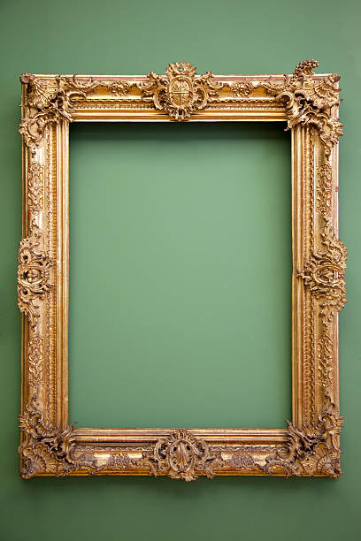 Empty golden baroque frame hanged in green wall stock photo