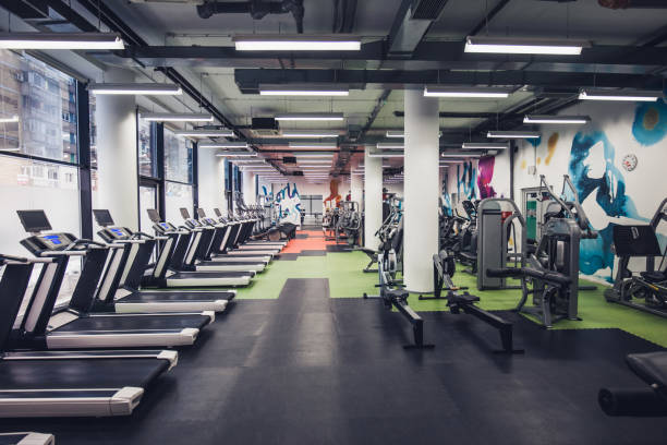 Empty gym! Large group of exercise machines in an empty gym. no people stock pictures, royalty-free photos & images