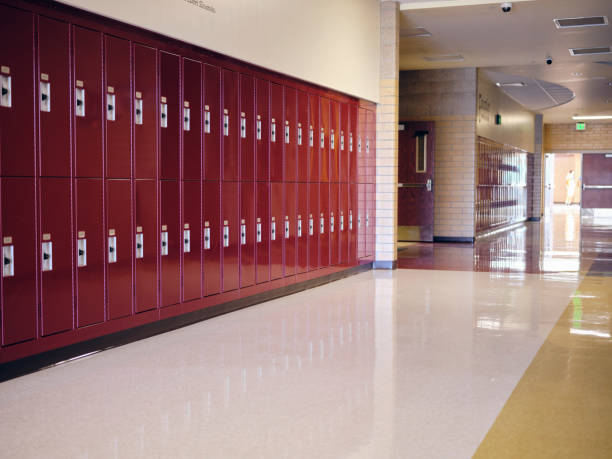 An empty hallway with lockers in a high school.