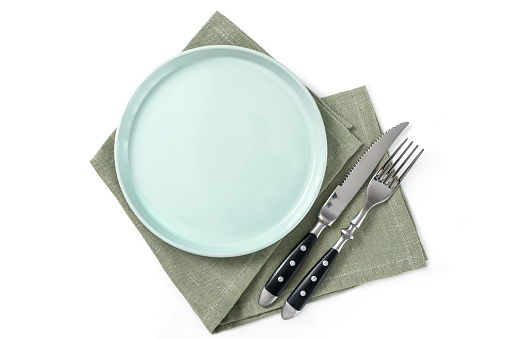 Empty isolated green plate on white bakground. Food background for menu, recipe. Table setting. Flatlay, top view. mockup for restaurant dish