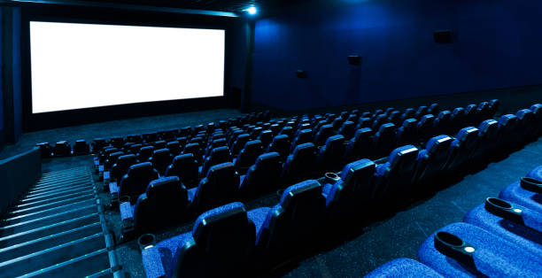 Empty movie theatre interior with screen and seats stock photo